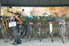 Bikes and a motorcycle parked at a bike rack